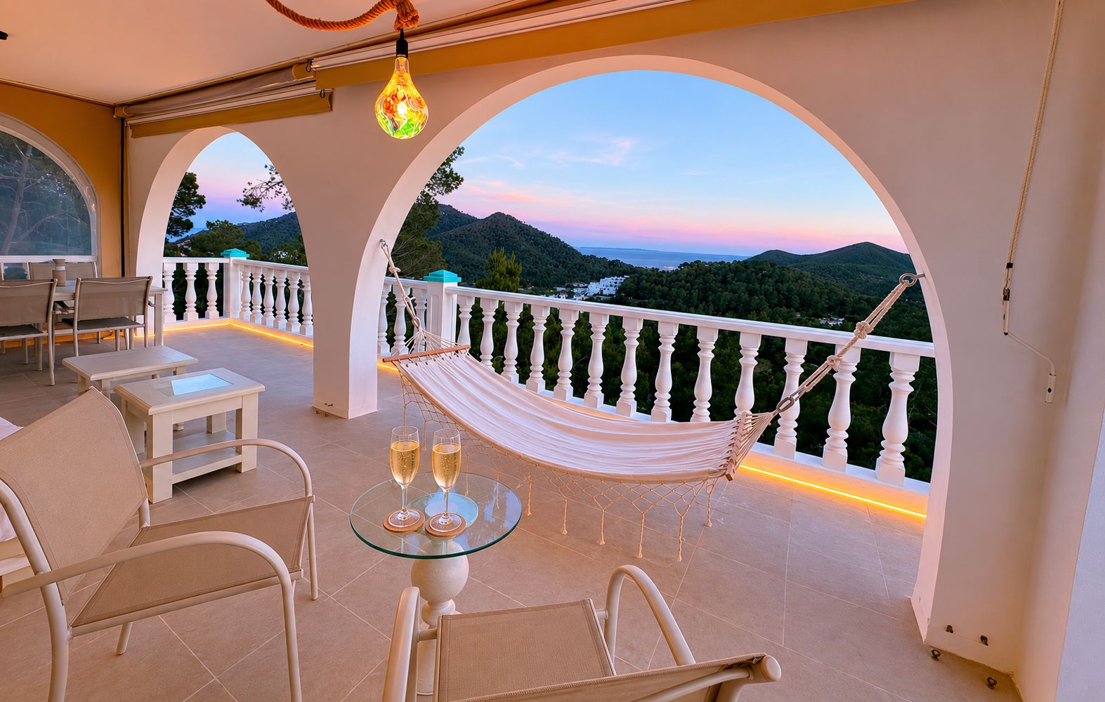 Terrasse der Casa Delfín mit Hängematte und Panoramablick bei Sonnenuntergang